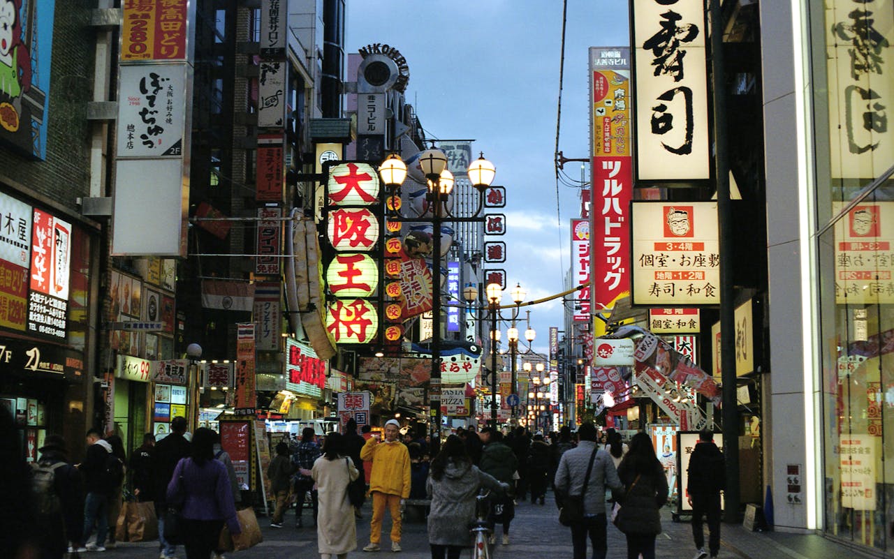 Explore the bustling streets of Dotonbori in Osaka, Japan, illuminated by traditional neon signs.
